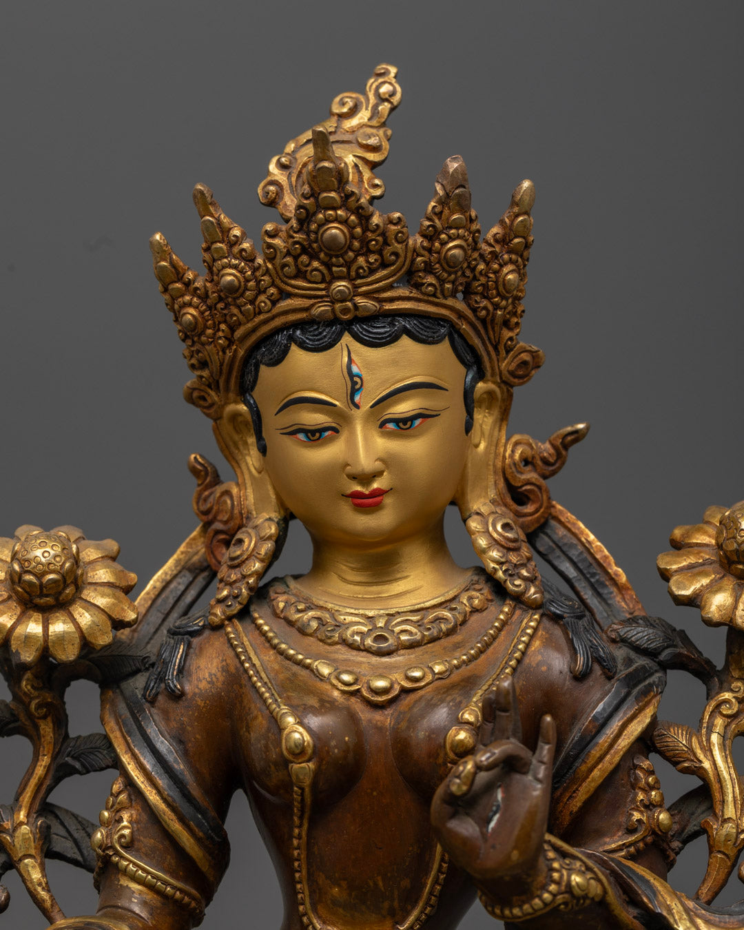 White Tara Statue featuring a blue utpala flower symbolizing purity, with symbolic eyes representing all-seeing wisdom.