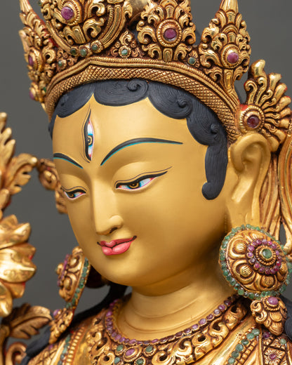 White Tara face from angle showing gold accents and 3D carvings