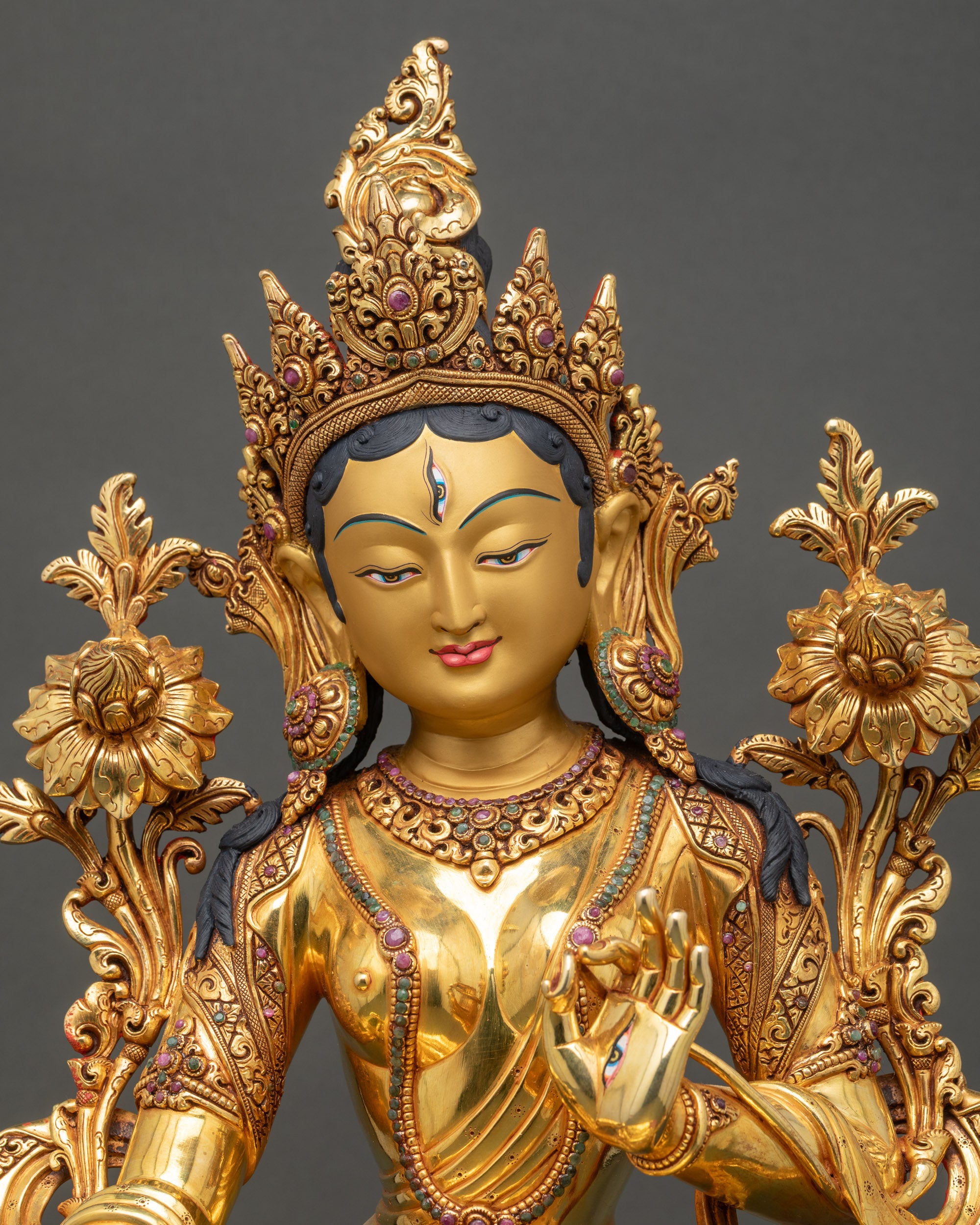 White Tara figurine close-up showing layered gold fire-gilding and lotus posturea