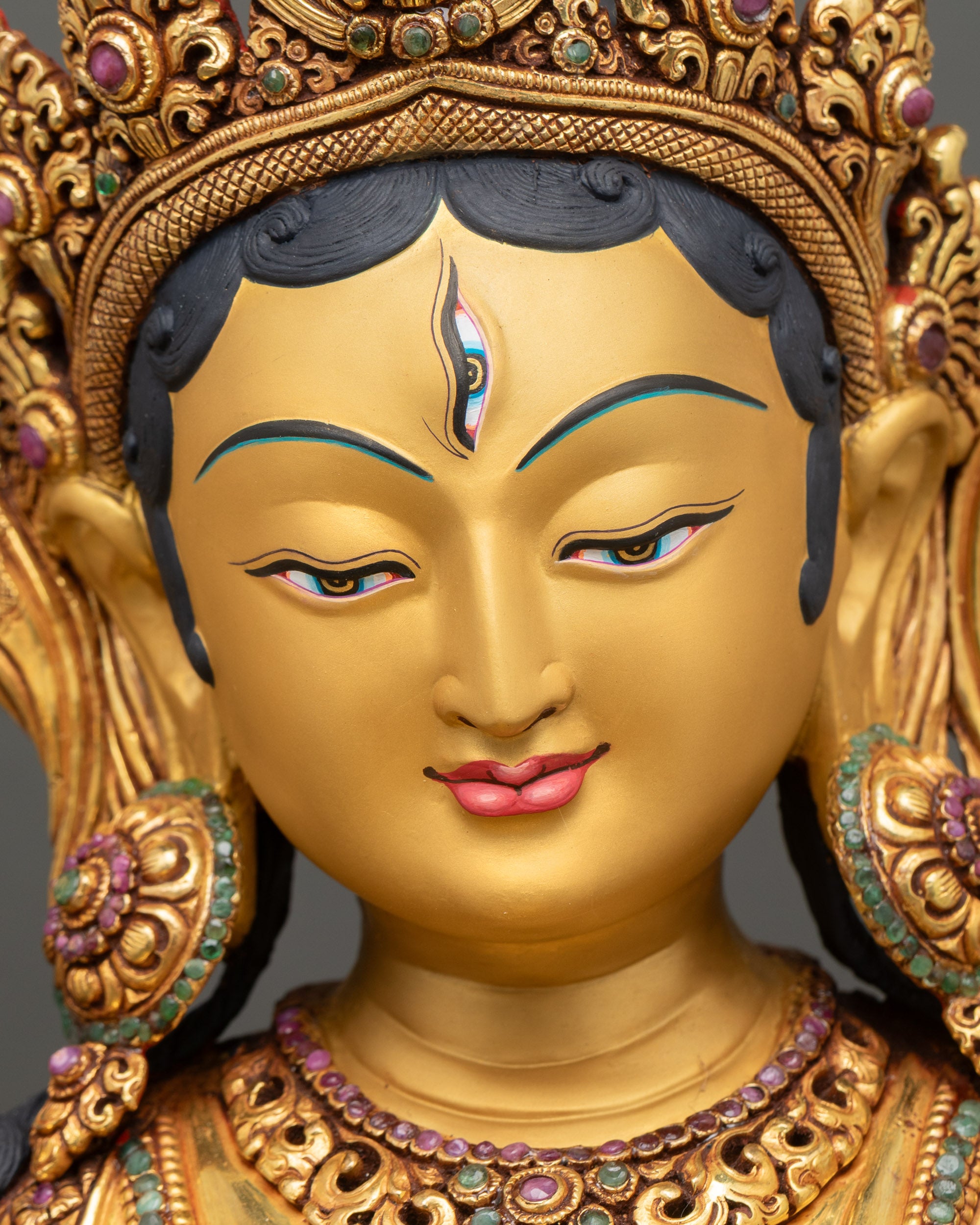 White Tara gold-painted face with serene expression and detailed craftsmanship