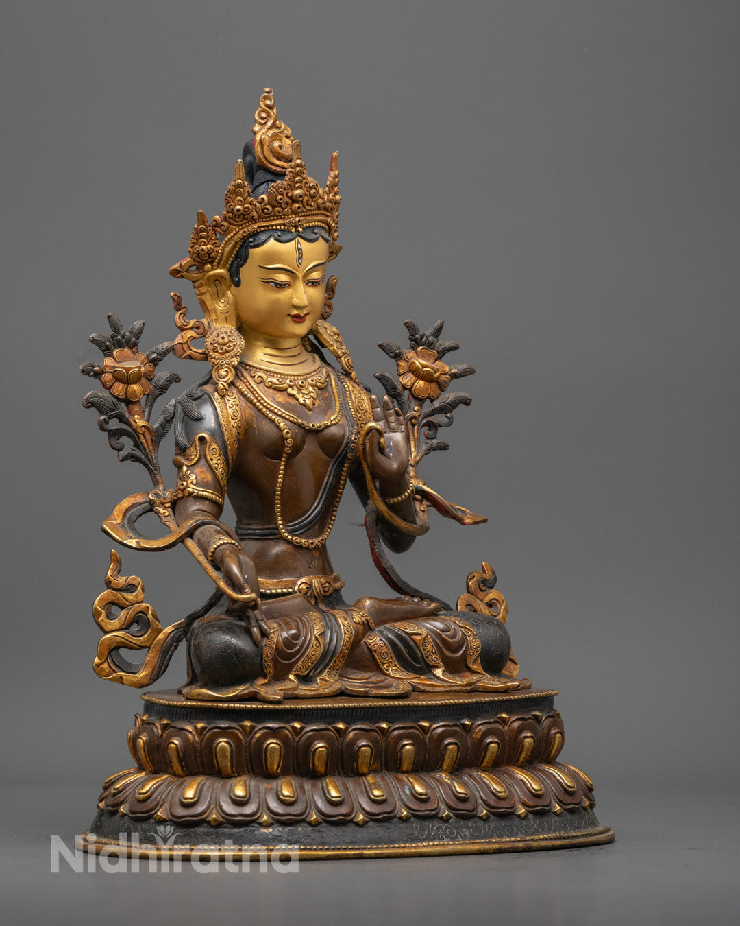 White Tara's serene 24k gold-gilded face with all-seeing eyes and acrylic-painted facial features.