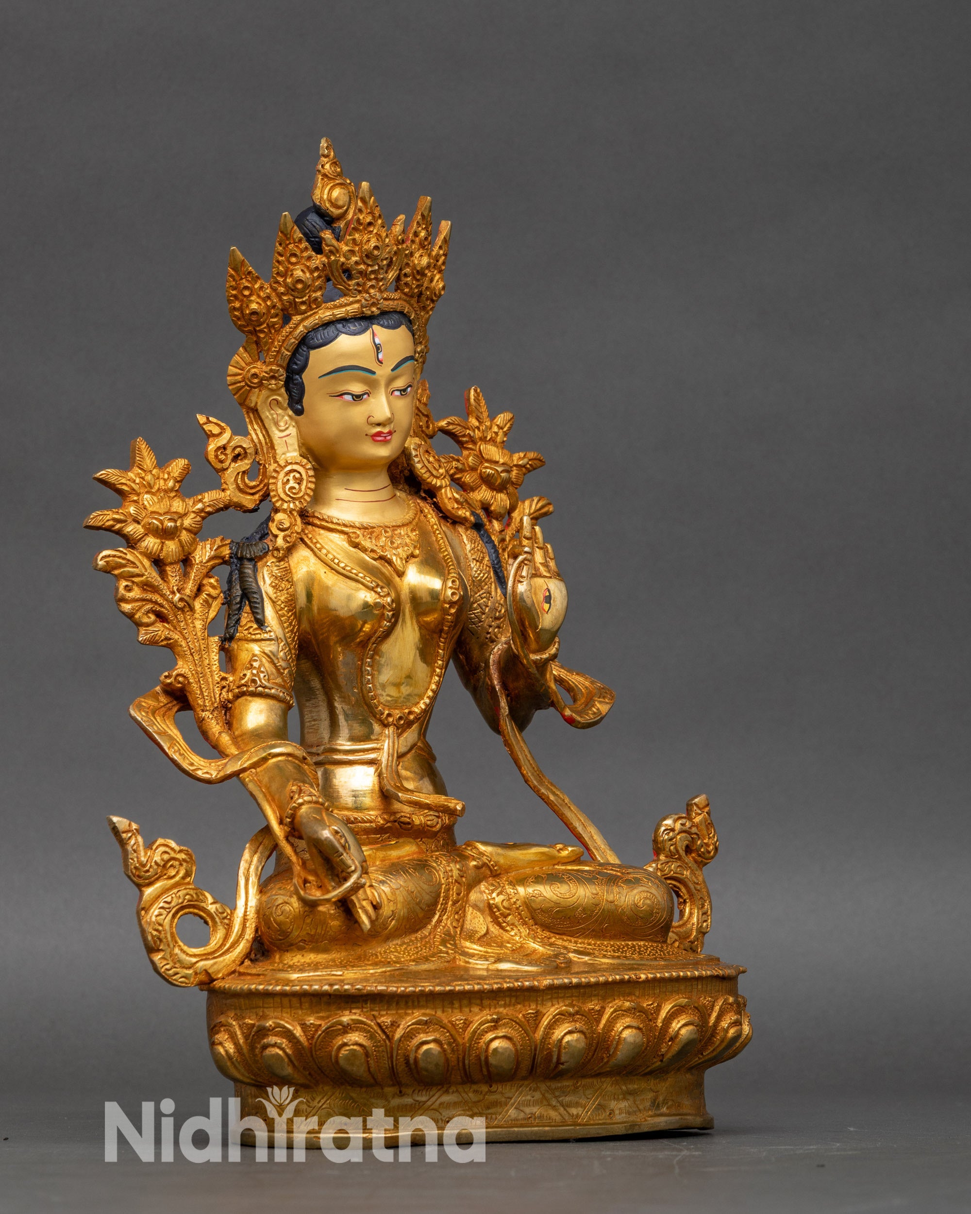 White Tara sculpture showing utpala flower and Varada Vitarka Mudra hand gestures