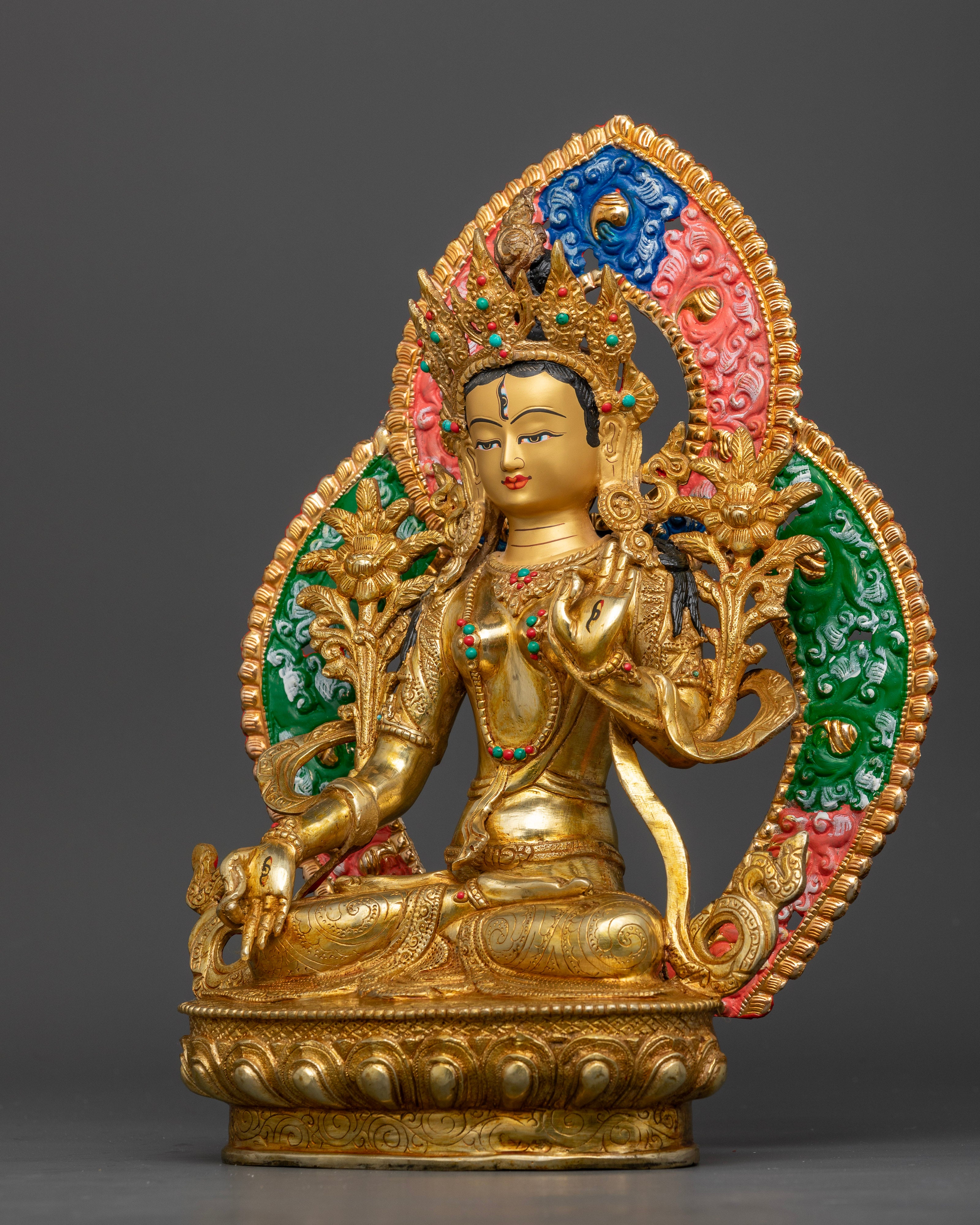 White Tara seated on lotus throne with extended leg, holding utpala flower and blessings hand