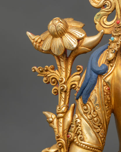 White Tara statue holding utpala flower, seven eyes symbolizing vigilance and protection