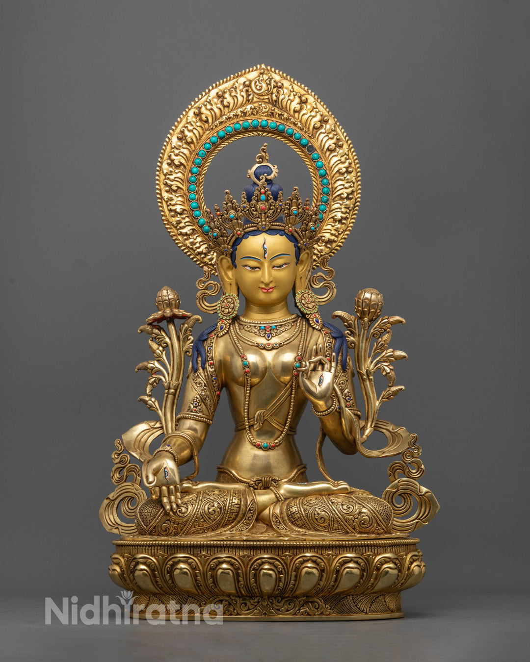 White Tara statue with a radiant halo, symbolizing compassion, healing, and long life, handcrafted in gold and copper for spiritual spaces.