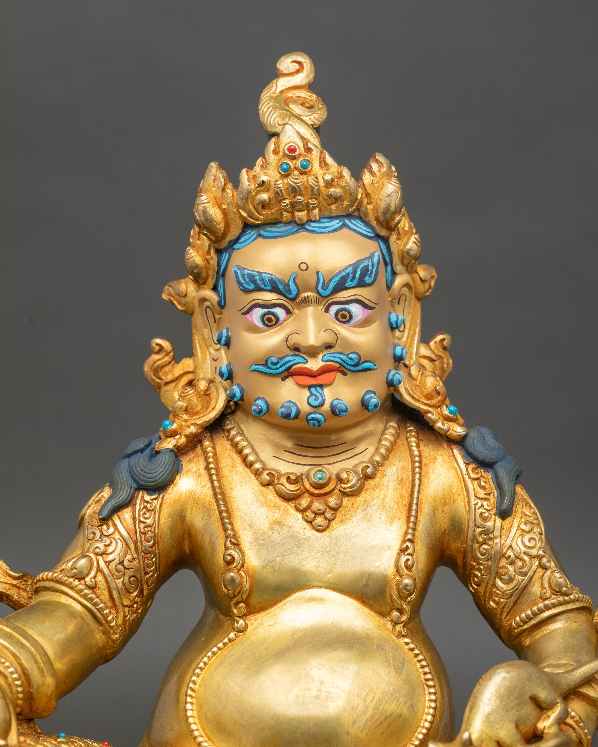 Yellow Dzambhala statue regular close-up, handcrafted Nepalese prosperity deity