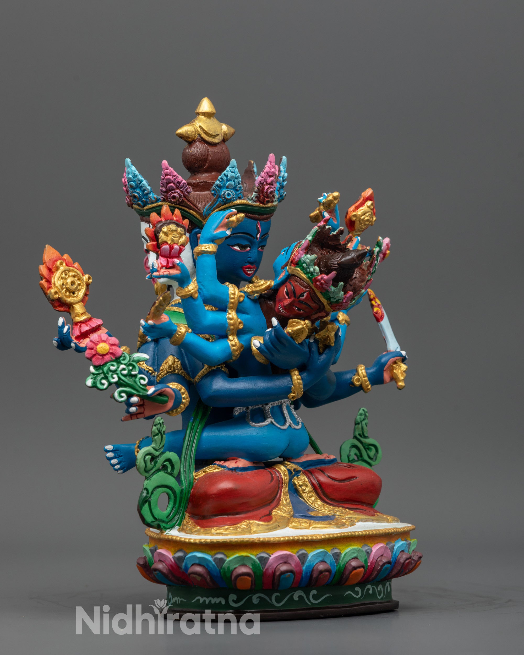 Side view of Guhyasamaja Consort Statue seated with Sparshavajra on lotus base in vibrant colors