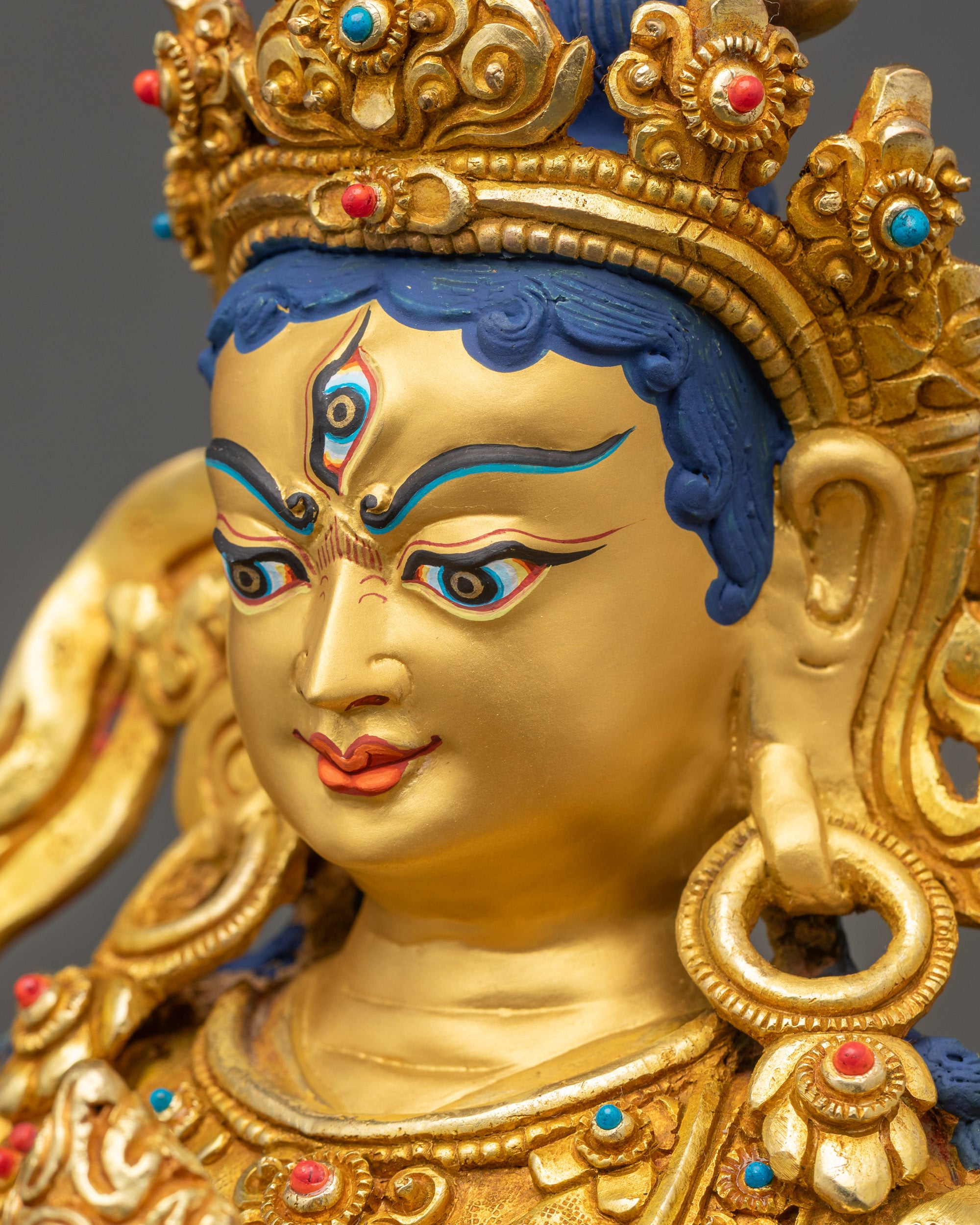 Side close up of Achi Chokyi Drolma statue face with shell crown and serene expression