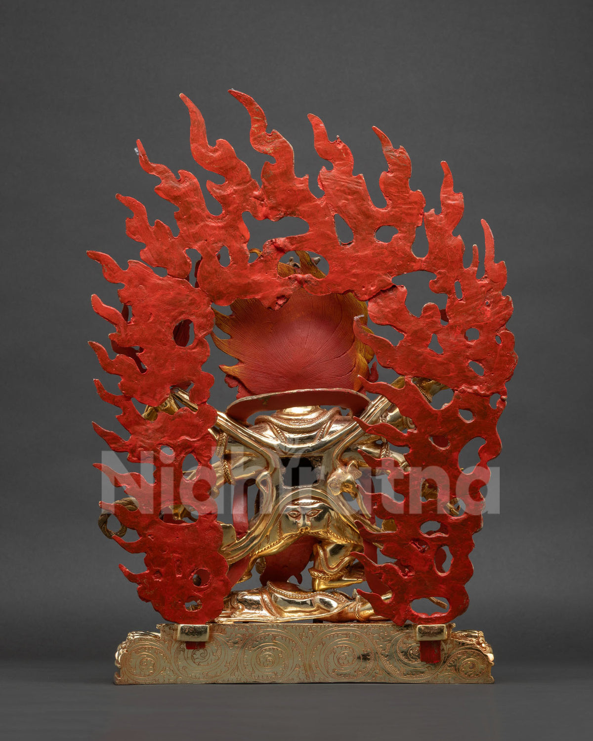 Back view of Six Arm Mahakala Statue showing red painted flame halo and engraved lotus base