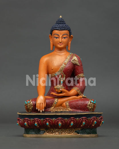 Acrylic-painted Shakyamuni Buddha statue with copper body and red robe from Nepal