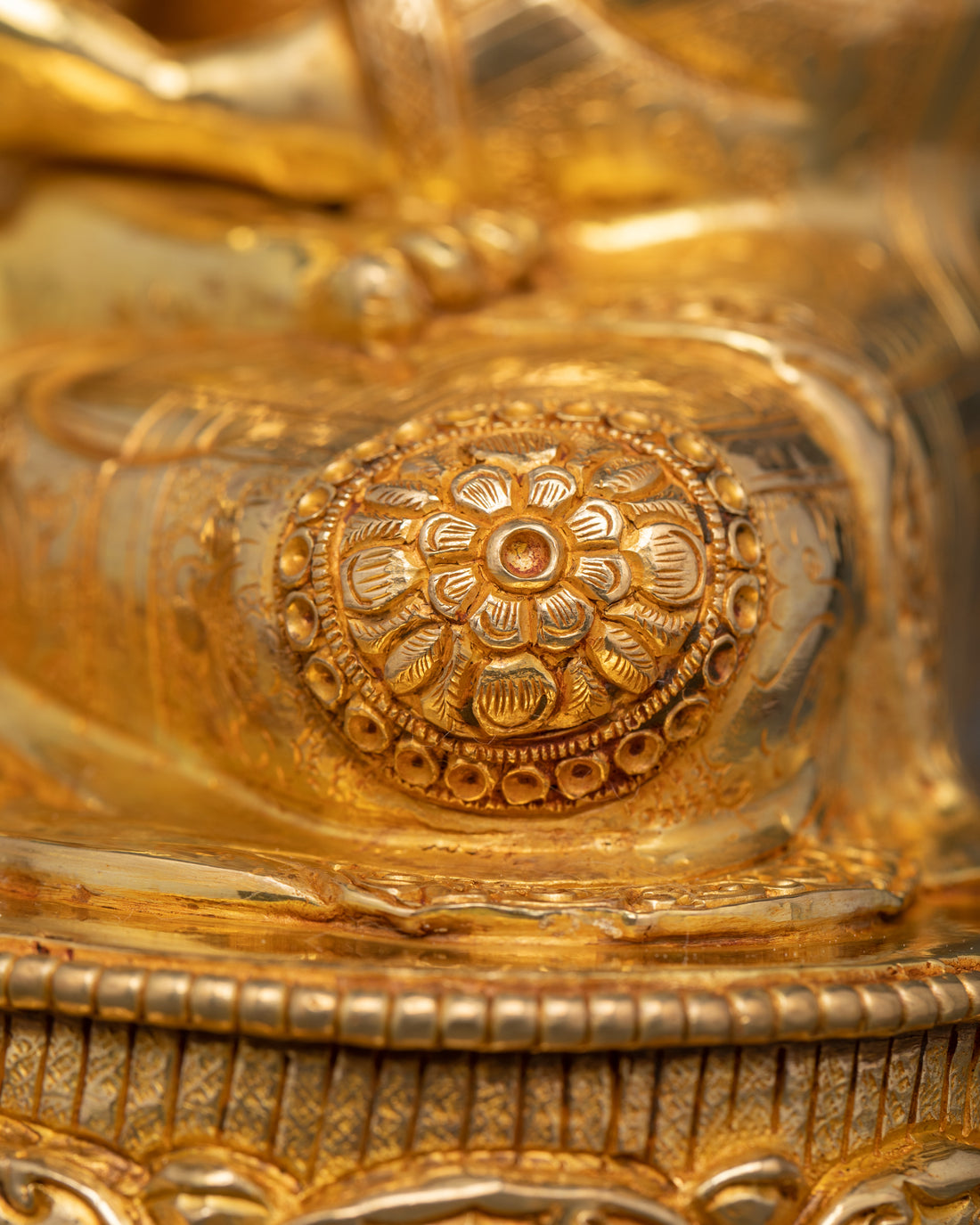 adorned leg of gold plated Shakyamuni Buddha statue