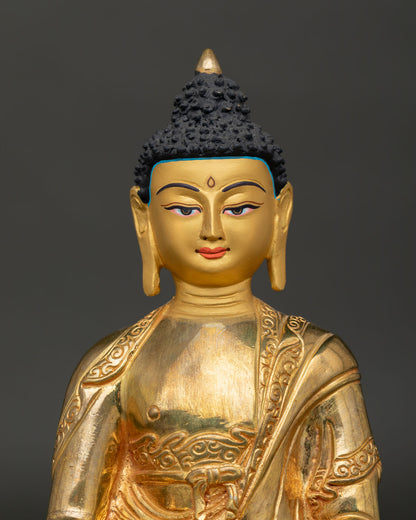 Amitabha buddha face showing gold painted details and serene meditation expression.