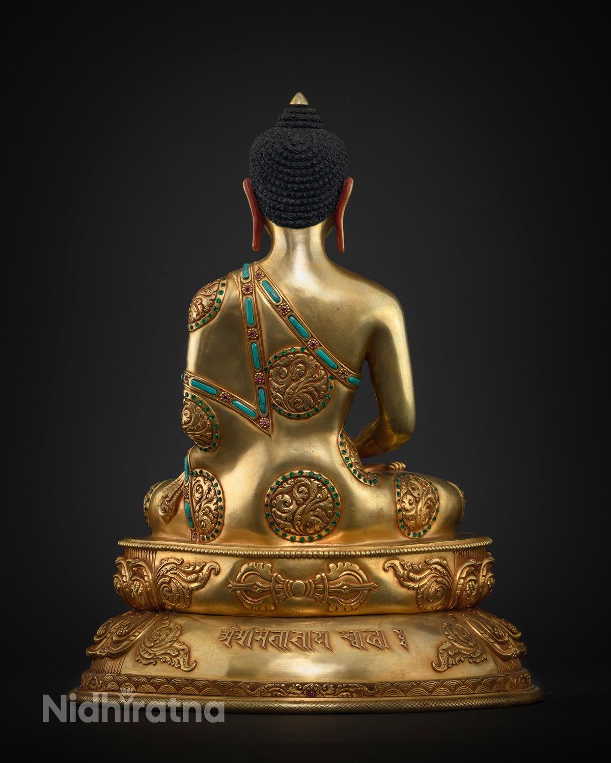 Back view of Amitabha Buddha statue showing Uchen mantra inscription on lotus throne
