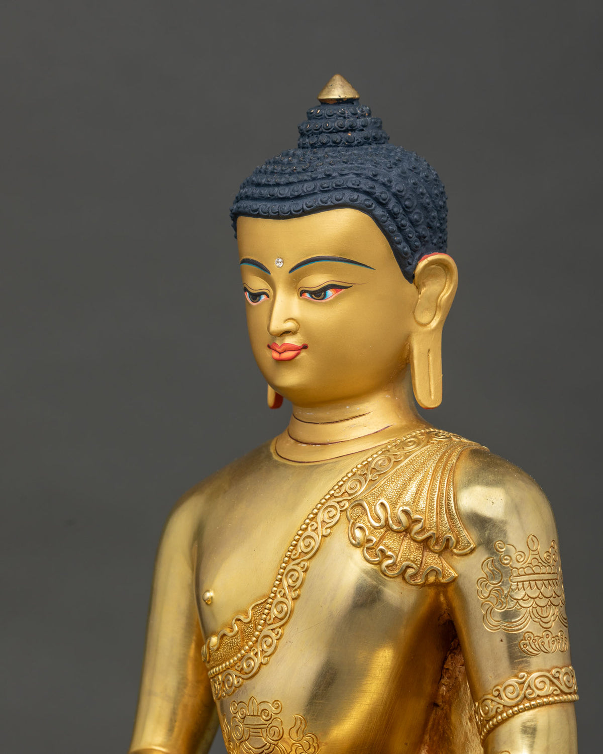 Amitabha Buddha Statue face close up 24K gold painted face.