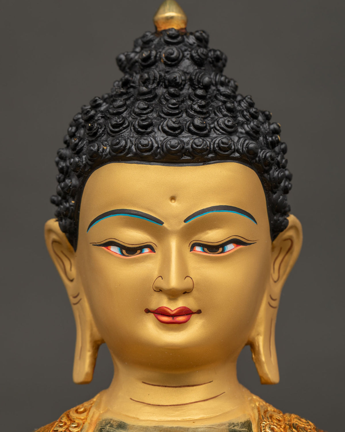 Amitabha Buddha statue face close up serene expression 24K gold.