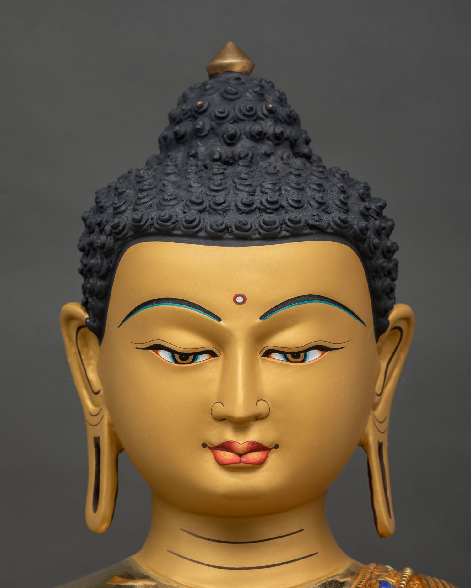Amitabha Buddha Statue face close-up, serene gold-painted expression