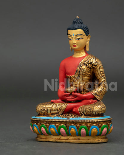 Amitabha Buddha statue seated in Dhyana Mudra holding alms bowl with gold gilded monk robe details.