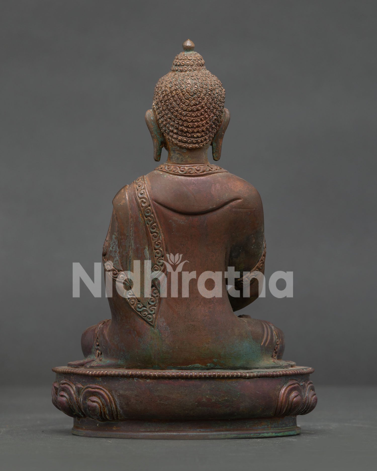 Amitabha Buddha statue side view showing intricate copper craftsmanship and lotus pedestal.