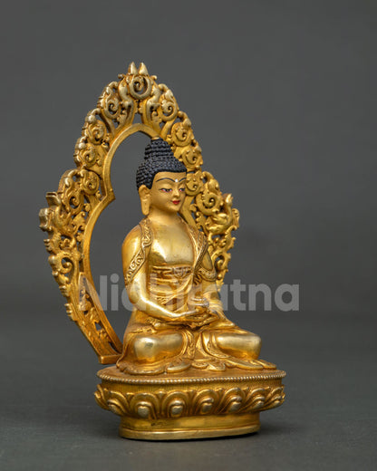 Amitabha Buddha statue with 24k gold painted face and ornate halo.