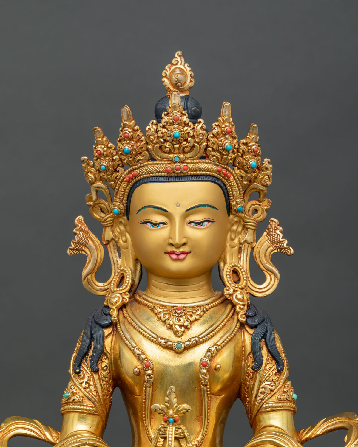 Amitayus Buddha Statue close up engraved robes semi precious stones crown.