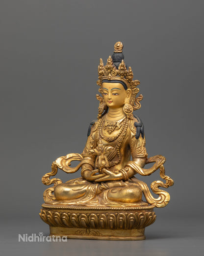 Amitayus Buddha statue seated on a hand carved lotus pedestal with intricate silk garments.