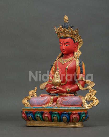 Amitayus Buddha statue adorned with layered necklaces gold gilded ornaments and semi precious stones.