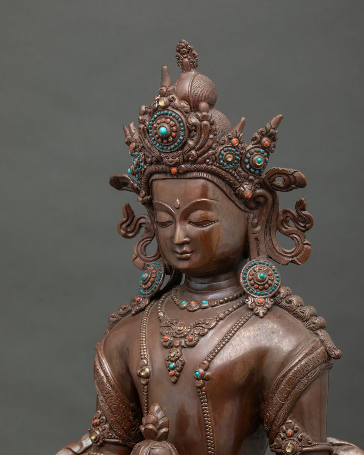 Amitayus statue holding kalasha sacred vase with delicately engraved robes.