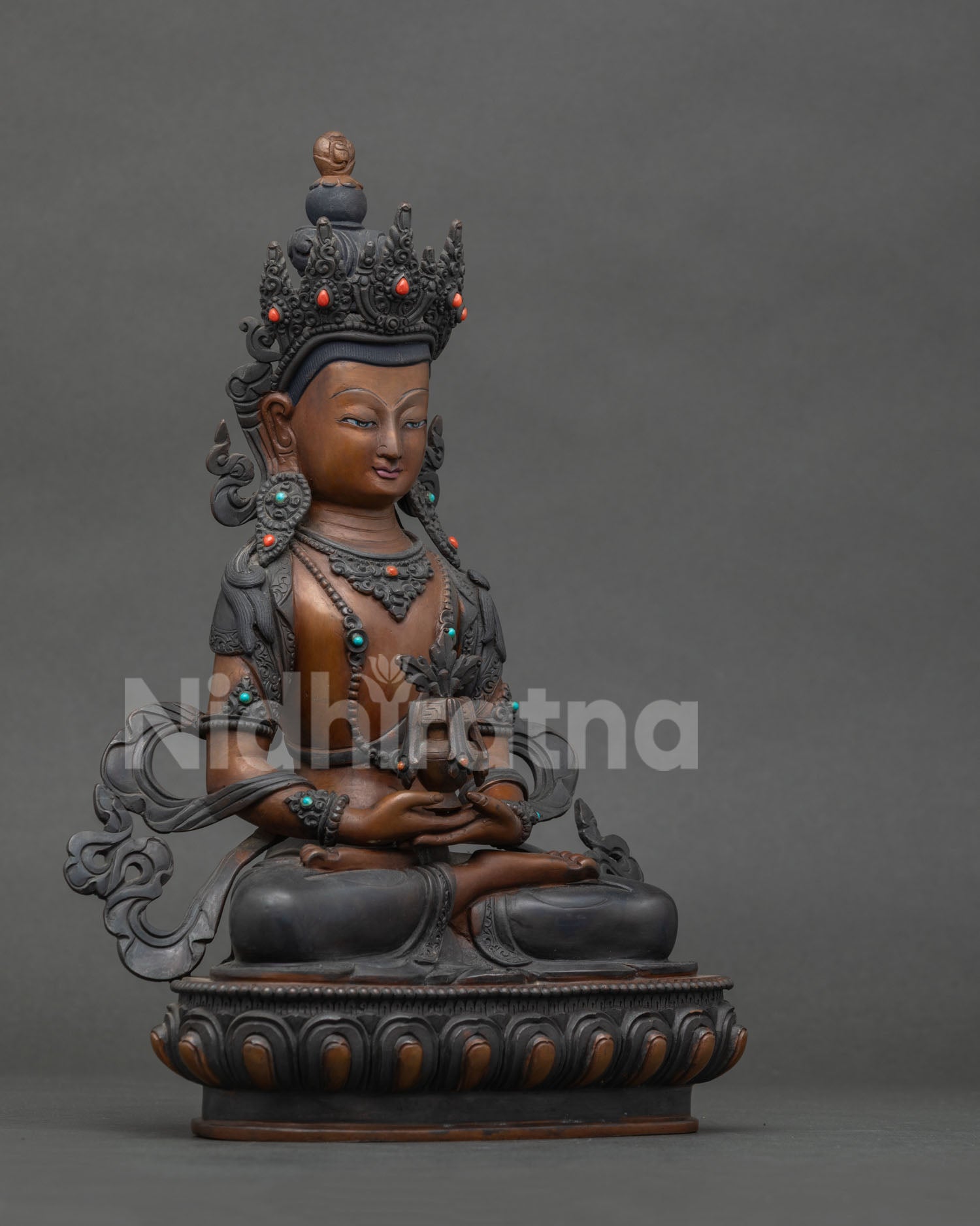 Amitayus Statue holding sacred vase of longevity in his lap.
