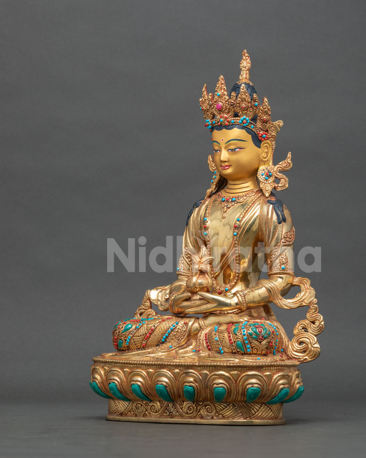 Amitayus statue semi precious stones patterned silk garment.