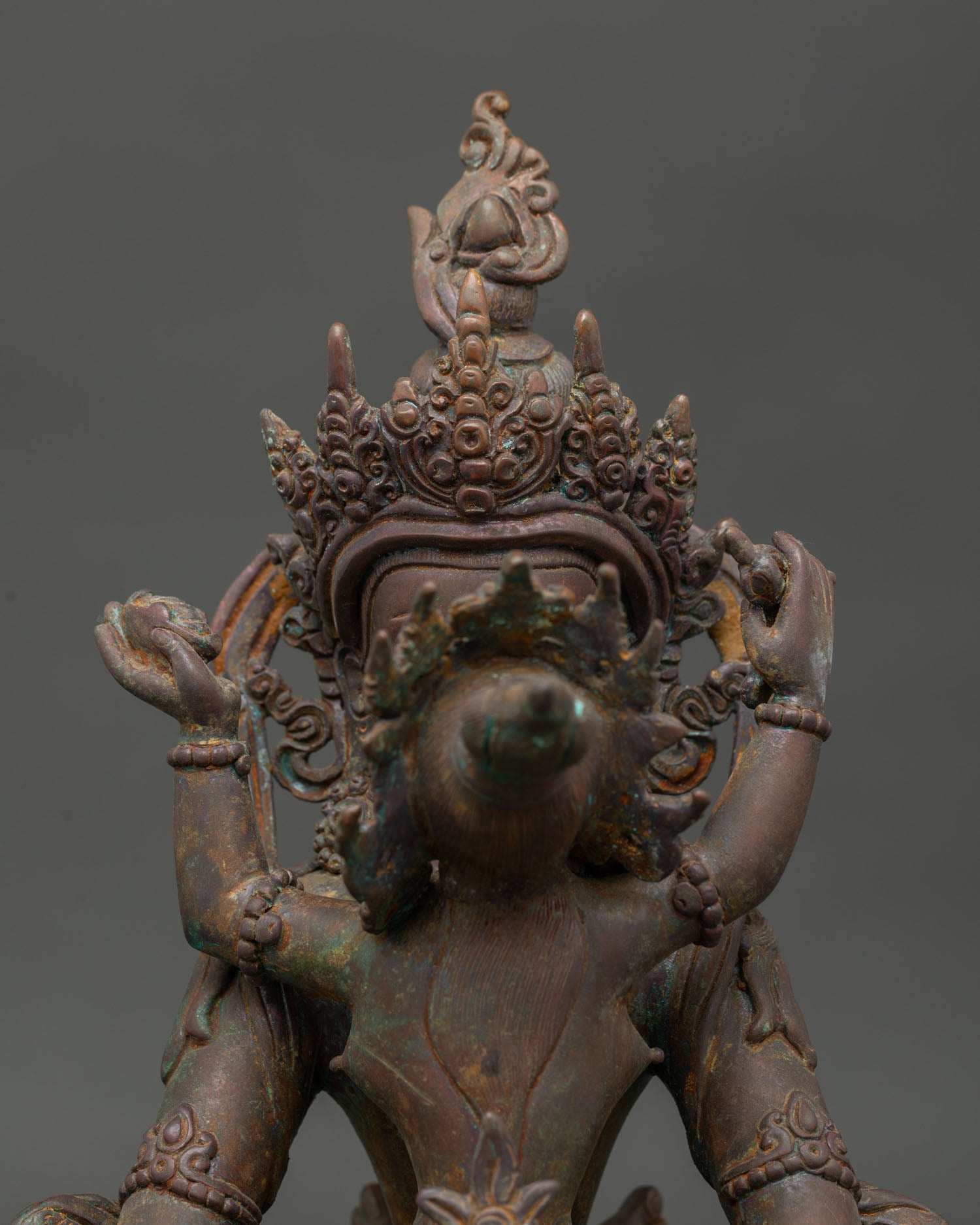 Amitayus with consort detailed face view with five jewel crown and layered necklaces.