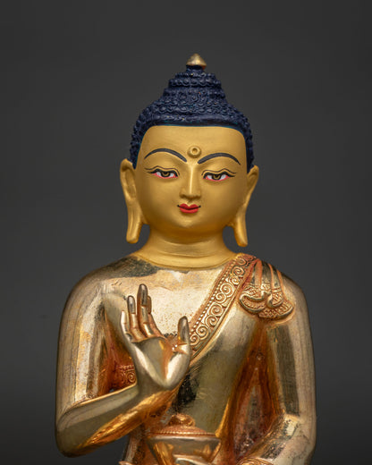 Amoghasiddhi Buddha statue close up 24K gold painted face and serene expression.