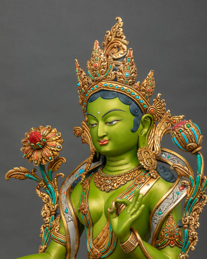 Angled close-up of Green Tara statue’s serene face, gold-gilded crown, and utpala flower, made in Nepal