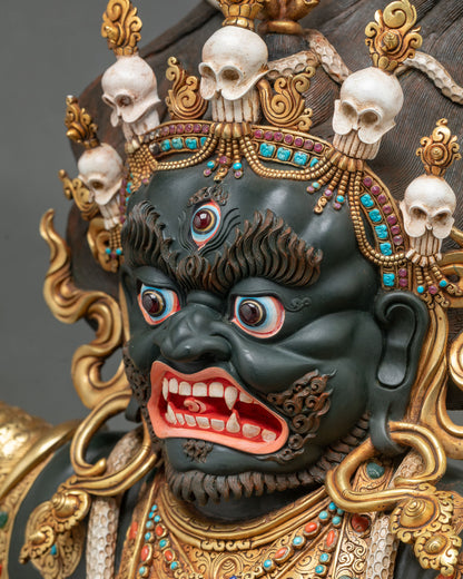 Angled close-up of Mahakala Bernagchen face with piercing gaze, fangs and hand-painted acrylics