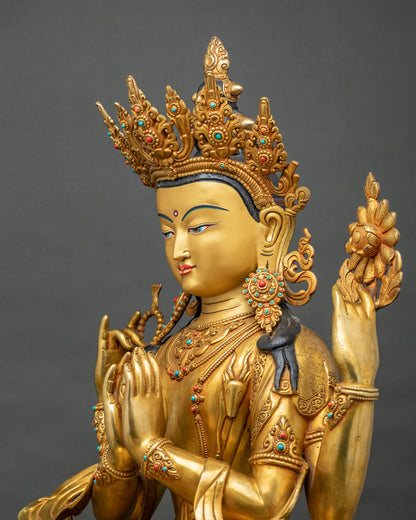 Angled view of four-armed Chenrezig statue holding crystal rosary and lotus blossom