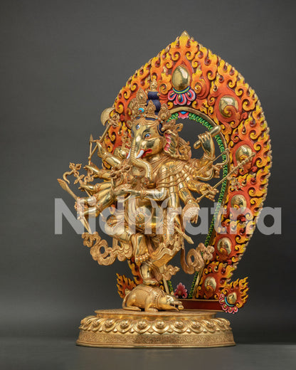 Angled view of multi-armed gold Ganesh statue upon mouse on lotus base pedestal