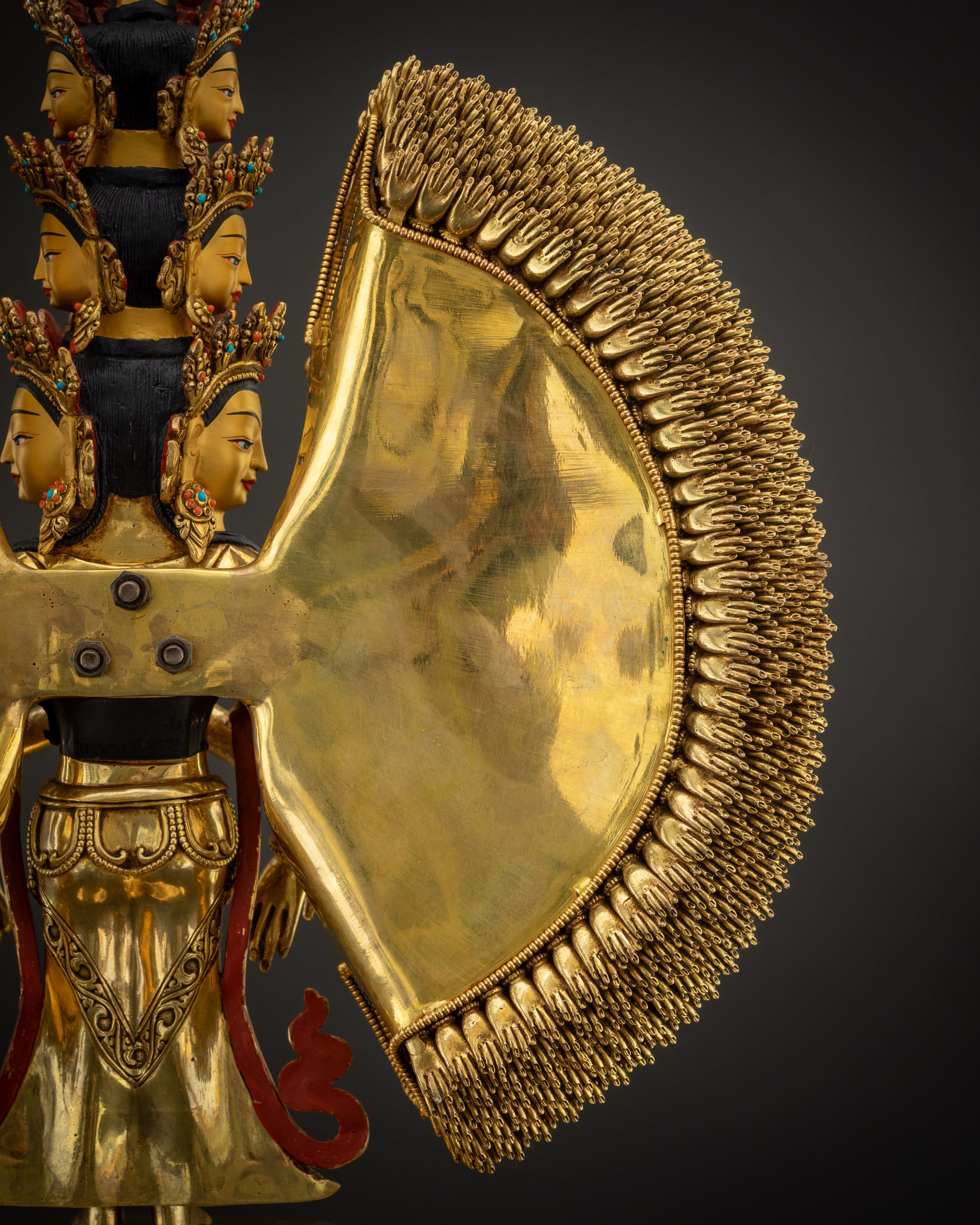 arm detail Thousand Armed Avalokiteshvara statue intricate hand and jewelry carvings
