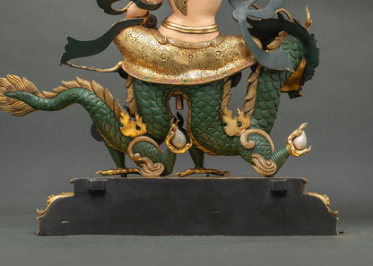 Back detail of White Dzambhala statue with hand-chased gold garment and inlaid semi-precious stones