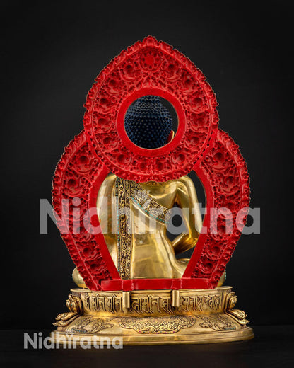 Back of Amitabha Buddha statue, red ornate floral halo, Tibetan mantra on base, Nepal