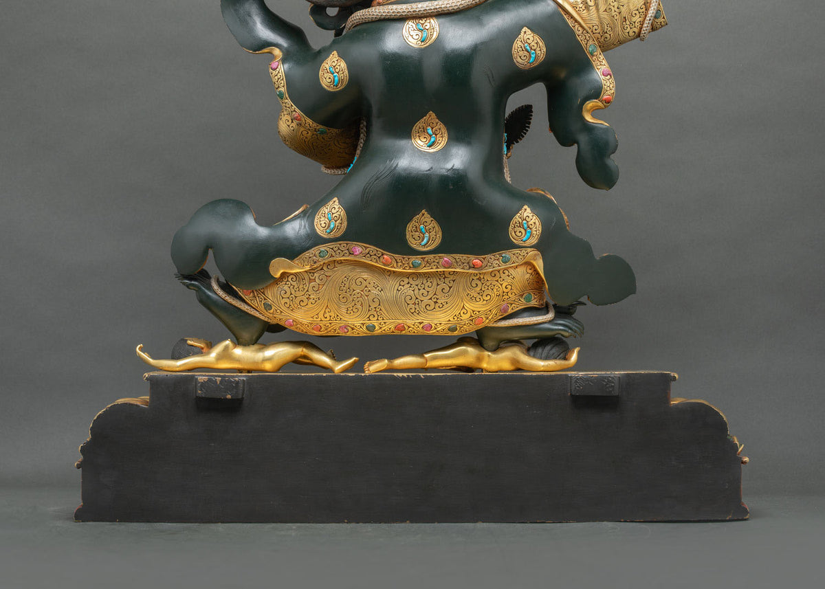 Back of Mahakala Bernagchen black cloak with gold teardrop medallions inlaid with turquoise
