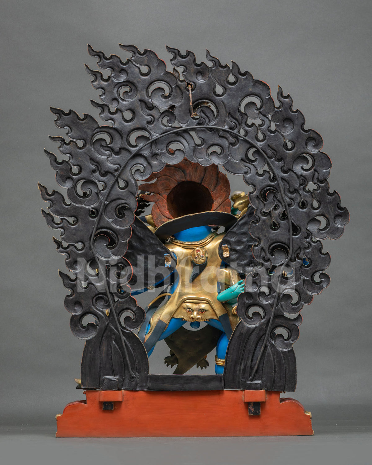 Back of Vajrakilaya statue with carved openwork flame halo and red painted base