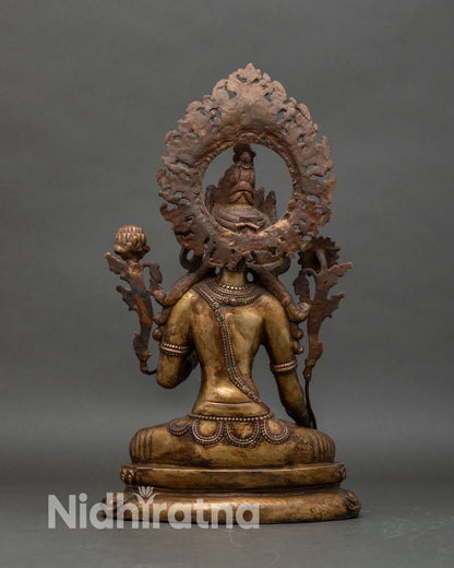 Back view of antique White Tara statue revealing halo structure and aged copper finish