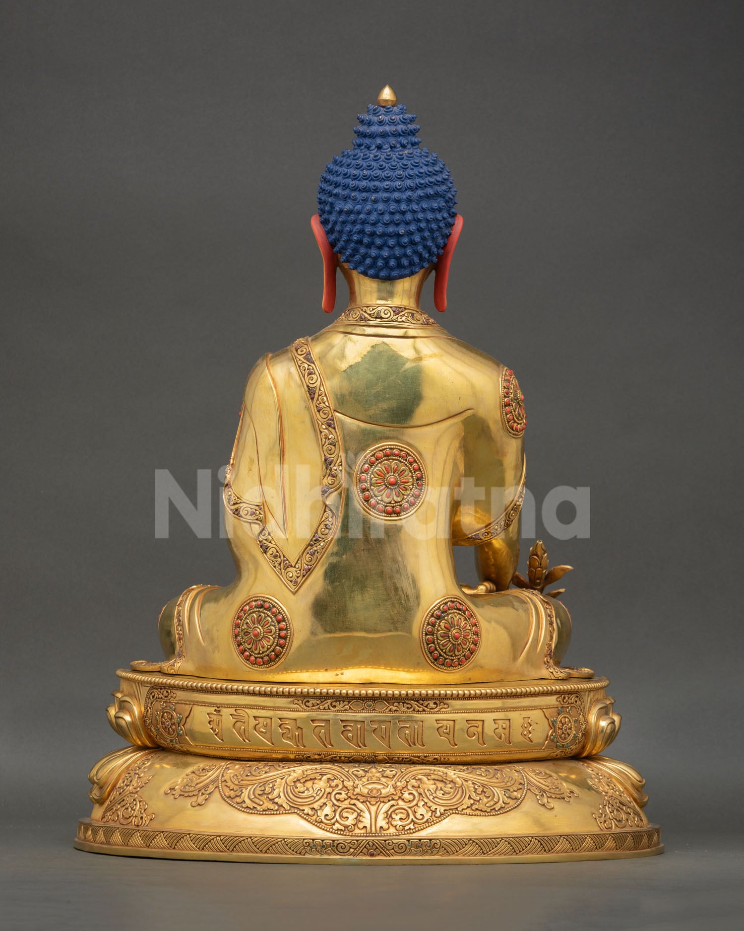 Back view of Medicine Buddha statue lotus pedestal, engraved mantras, floral scroll robe, semi precious stones, Himalayan sacred Buddhist healing sculpture