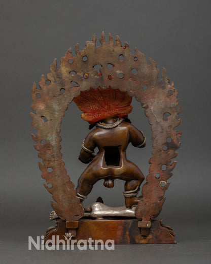 Back view Black Dzambhala sculpture intricate robes halo detailing oxidized copper finish Nepalese handcrafted Buddhist wealth god statue