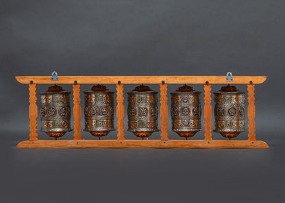 Back view of carved wooden frame copper prayer wheel set meditation tool