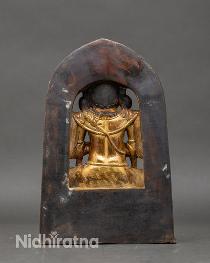 back-view chaturbhuja mahakala statue torana arch and engraved sacred motifs