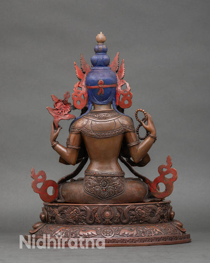 Back view of Chenrezig statue with intricate carving in oxidized Nepalese art