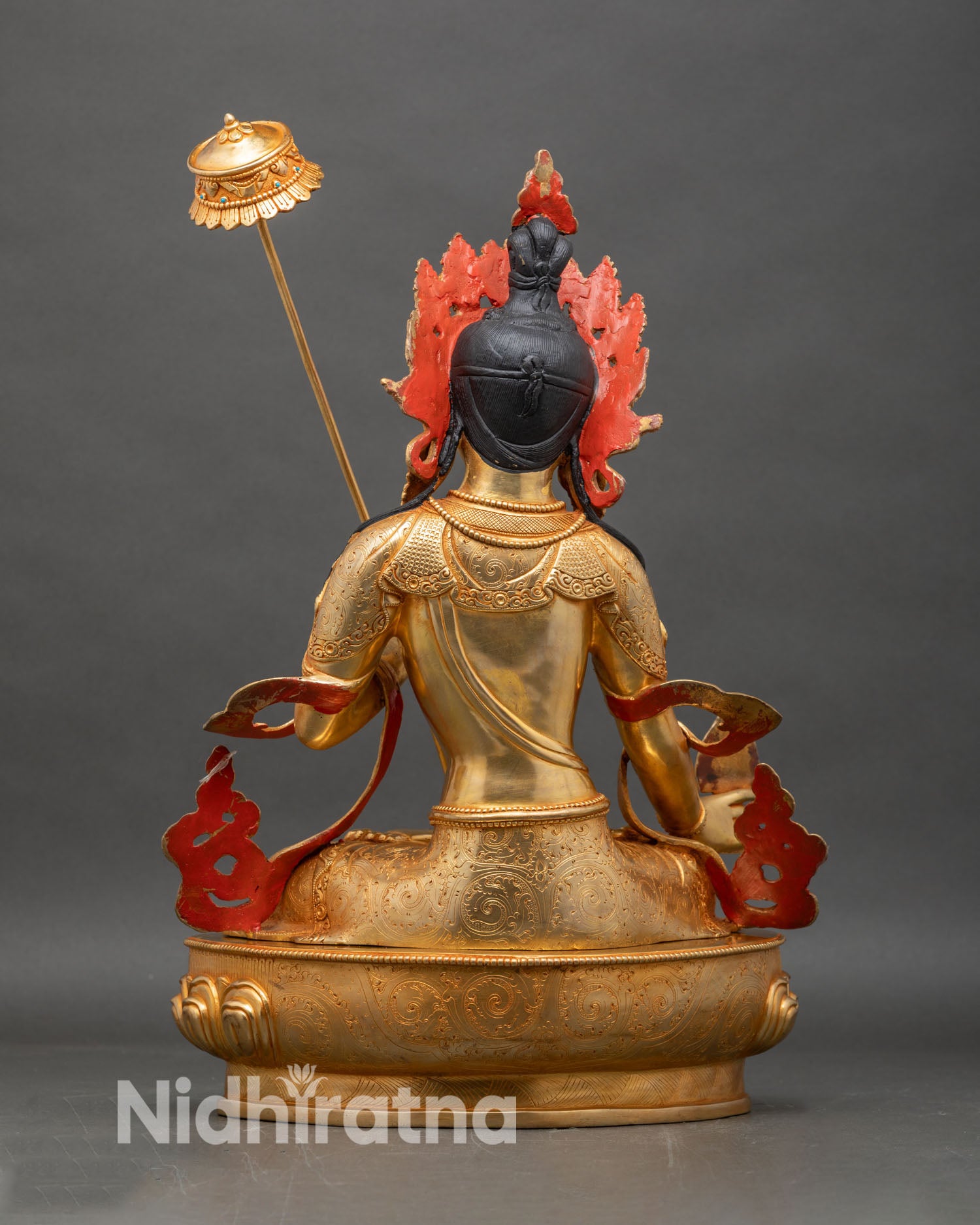 Back view of Dukar statue, lotus pedestal, ornate gold and copper design, vibrant ritual colors