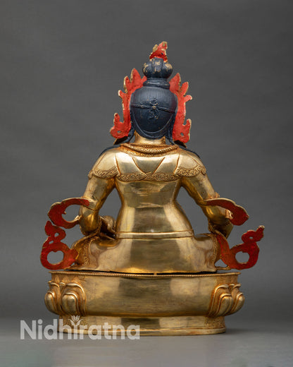 Back view of Dzambhala statue showing engraved lotus throne and traditional design