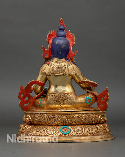 Back view of Dzambhala statue, lotus seat and engraved traditional patterns