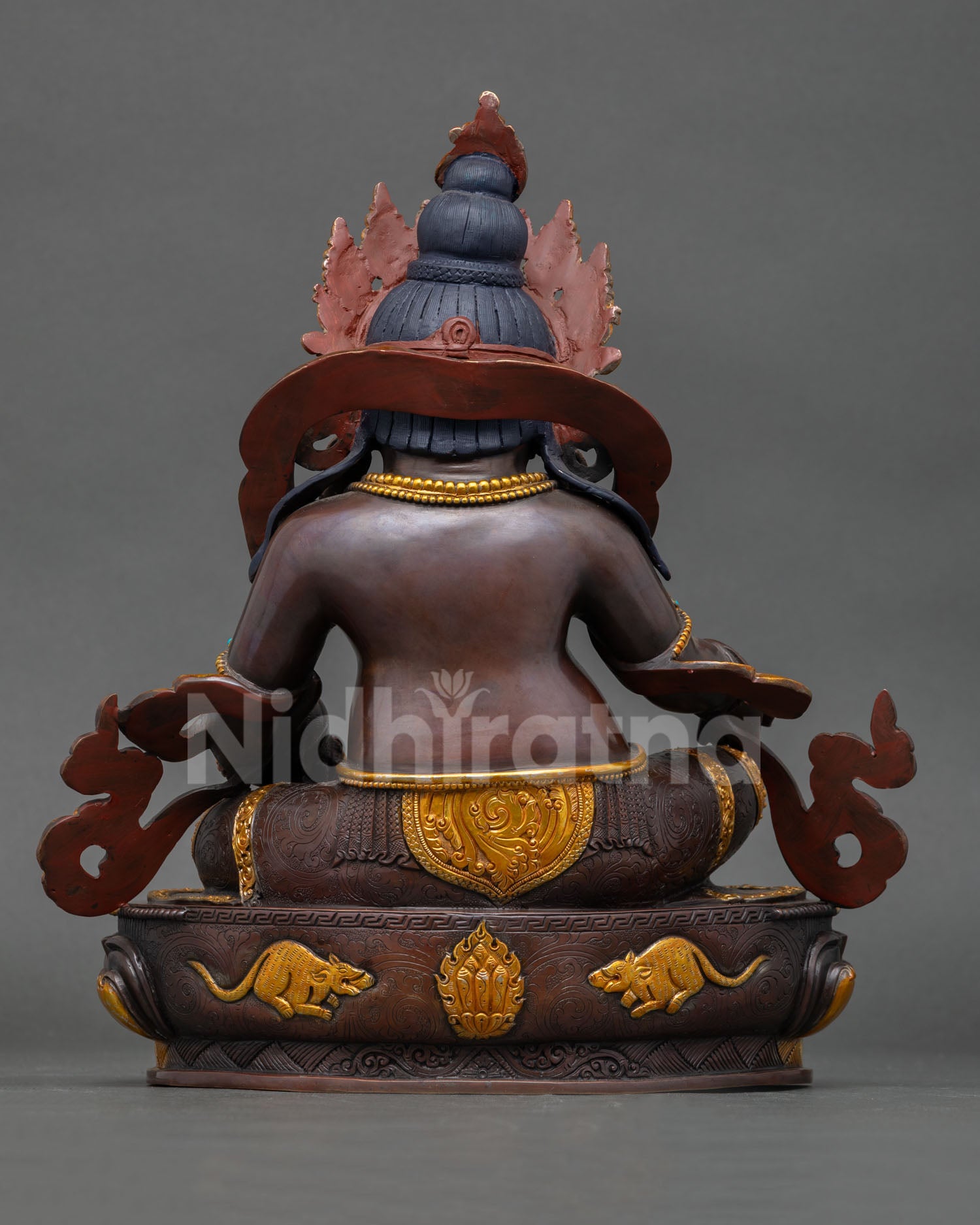 Back view Dzambhala statue Nepal handcrafted Buddhist art with detailed lotus throne carving